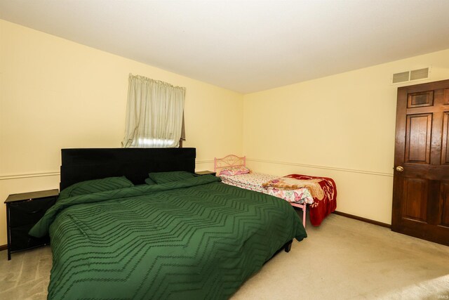 bedroom with light colored carpet