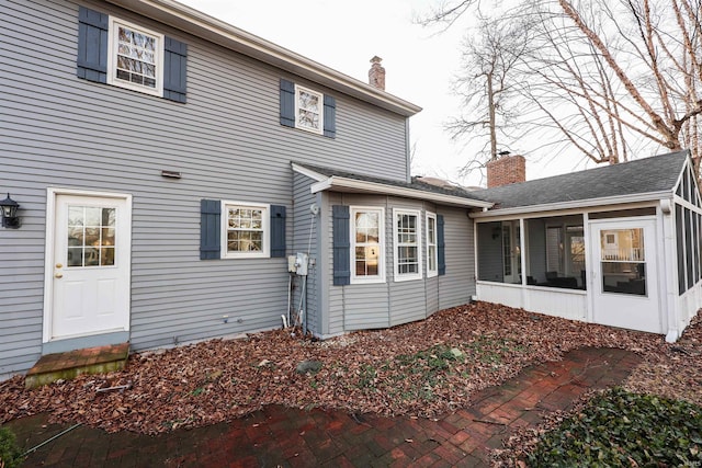 rear view of property with a sunroom