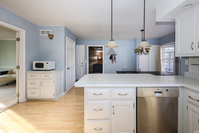 kitchen with white cabinetry, dishwasher, kitchen peninsula, and hanging light fixtures