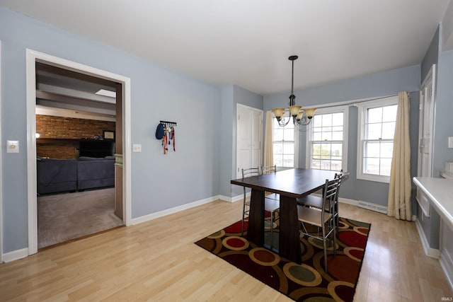 dining area featuring an inviting chandelier and light wood-type flooring