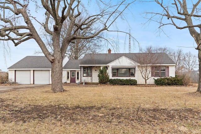 ranch-style home featuring a garage and a front lawn