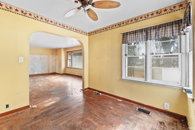 empty room with ceiling fan and wood-type flooring