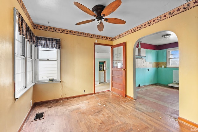 unfurnished room featuring ceiling fan and wood-type flooring