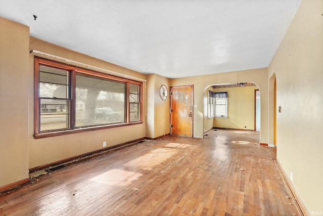 unfurnished room with hardwood / wood-style flooring