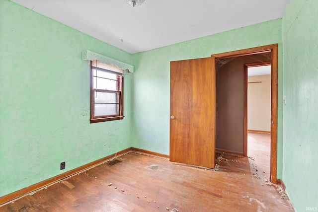 unfurnished bedroom with hardwood / wood-style floors