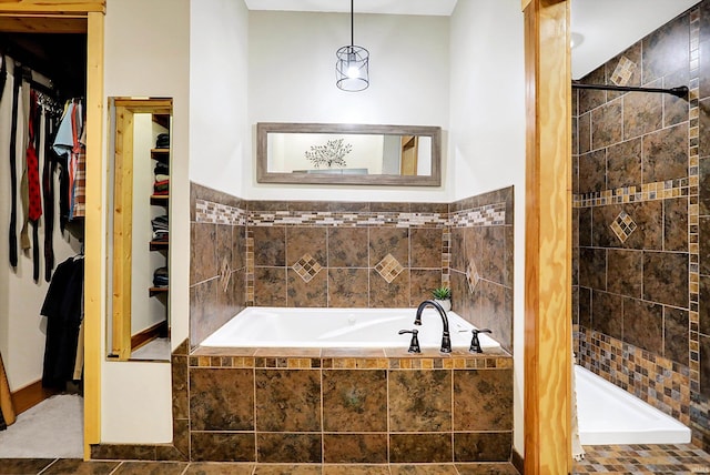 bathroom featuring tile patterned flooring and separate shower and tub