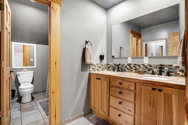 bathroom featuring vanity, decorative backsplash, tile patterned floors, and toilet