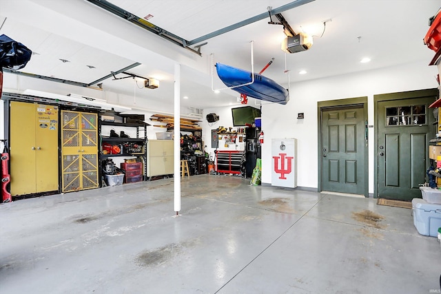 garage with a garage door opener and a workshop area