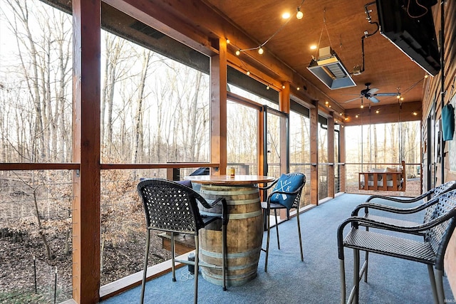 sunroom featuring ceiling fan