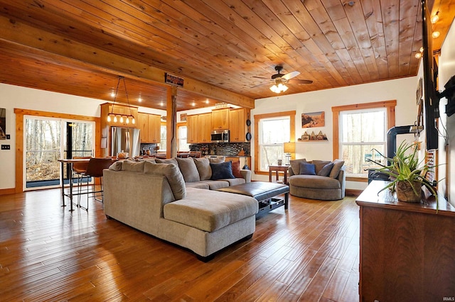 living room featuring hardwood / wood-style flooring, ceiling fan, and wooden ceiling