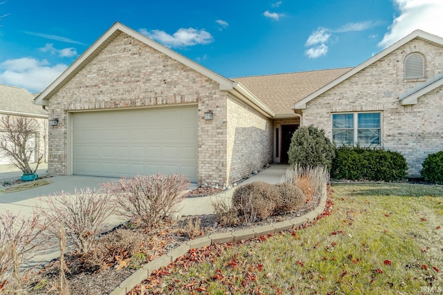 ranch-style house featuring a garage and a front lawn