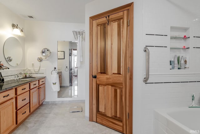 bathroom featuring tile patterned flooring and vanity