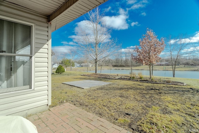 view of yard with a patio and a water view