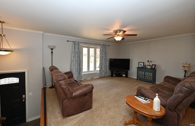 living room featuring ornamental molding, ceiling fan, and carpet