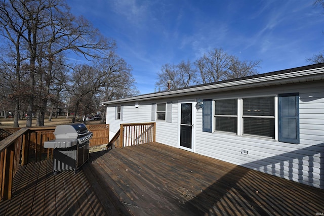 wooden terrace featuring a grill