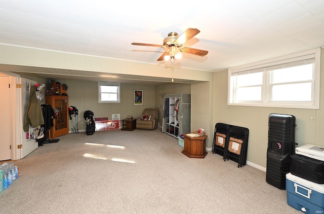 interior space featuring ceiling fan and light colored carpet