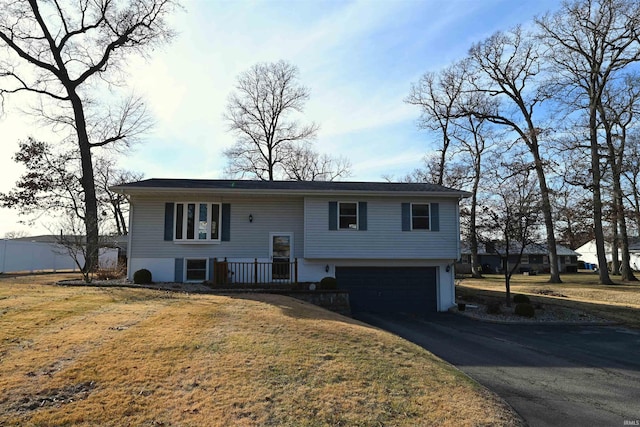 bi-level home with a garage and a front lawn