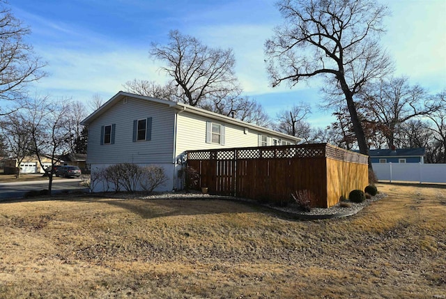 view of property exterior with a lawn