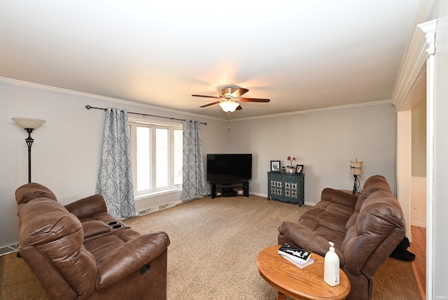 carpeted living room with ornamental molding and ceiling fan