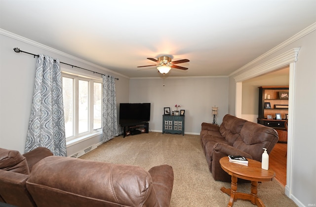 carpeted living room with ceiling fan and ornamental molding