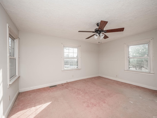 empty room with carpet floors and a textured ceiling