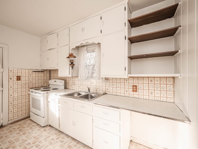 kitchen featuring sink, white cabinetry, tile walls, white range with electric cooktop, and backsplash