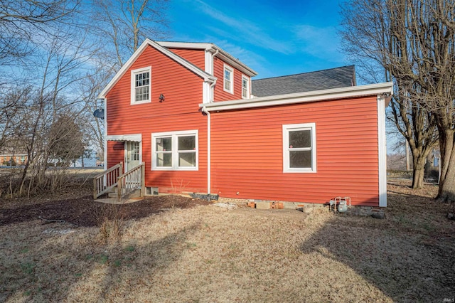 rear view of house with a yard