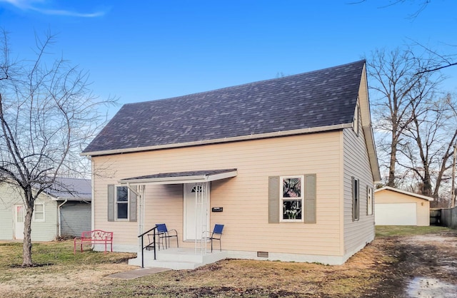 view of front of home with a garage and an outdoor structure