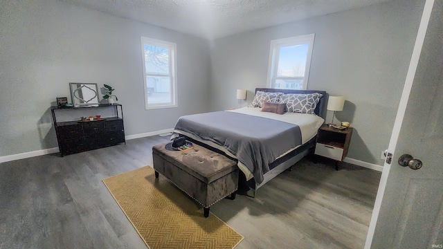 bedroom with wood-type flooring and a textured ceiling