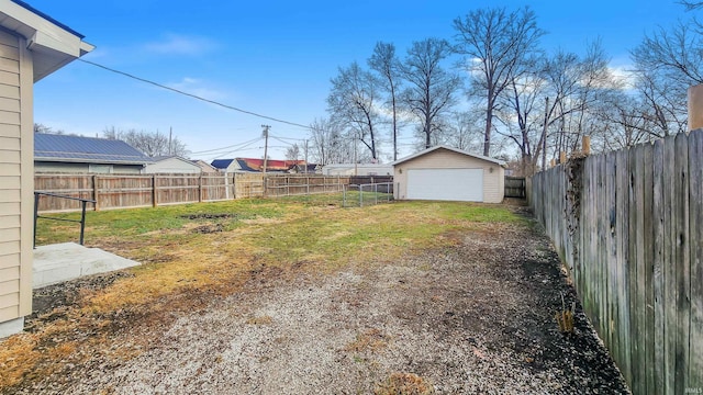 view of yard featuring a garage and an outdoor structure