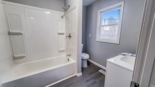 full bathroom featuring vanity, wood-type flooring, bathing tub / shower combination, and toilet