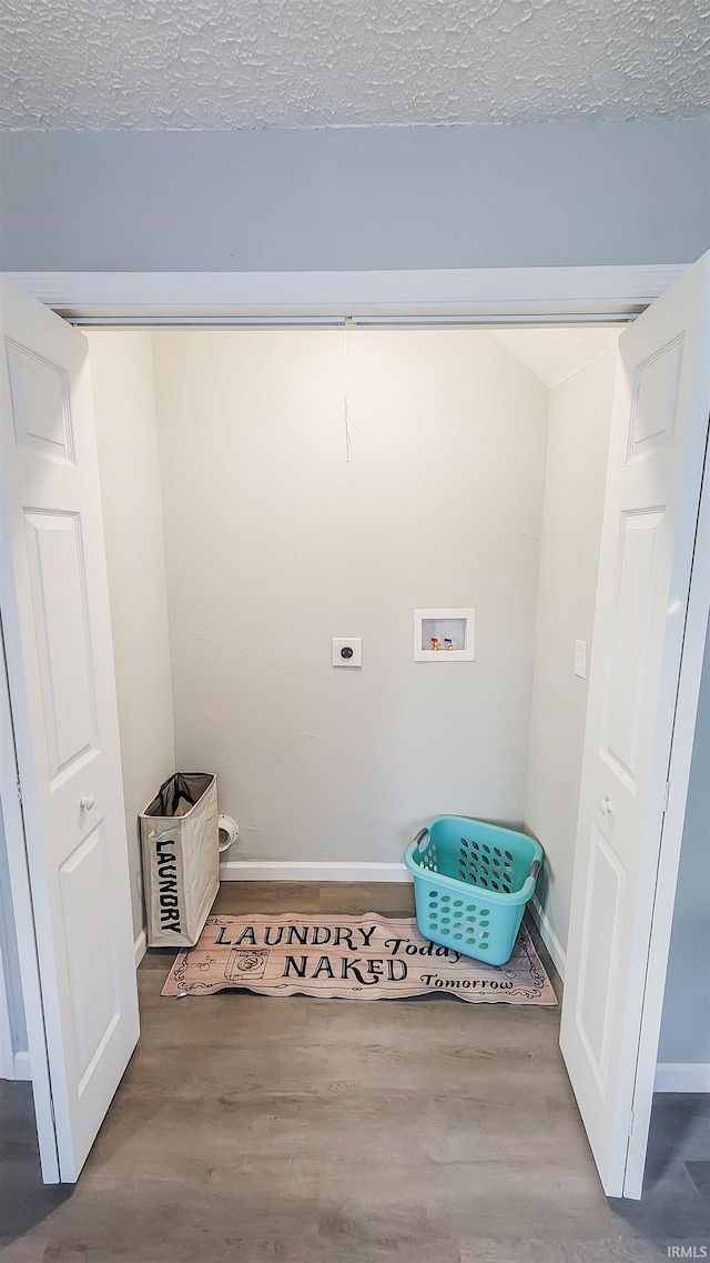 laundry area with washer hookup, hookup for an electric dryer, wood-type flooring, and a textured ceiling