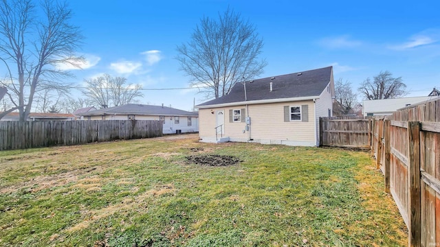 back of house with a lawn