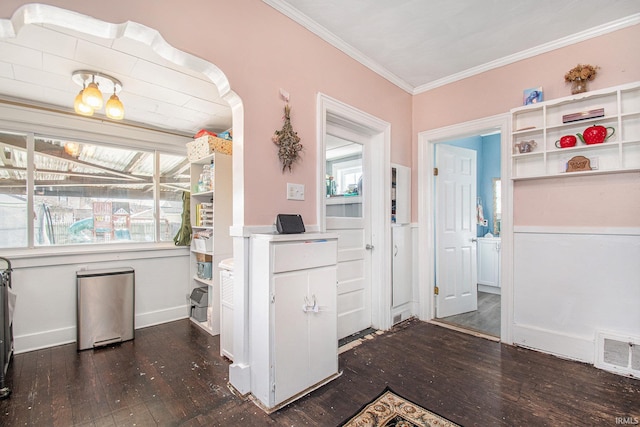 kitchen with ornamental molding and dark hardwood / wood-style floors