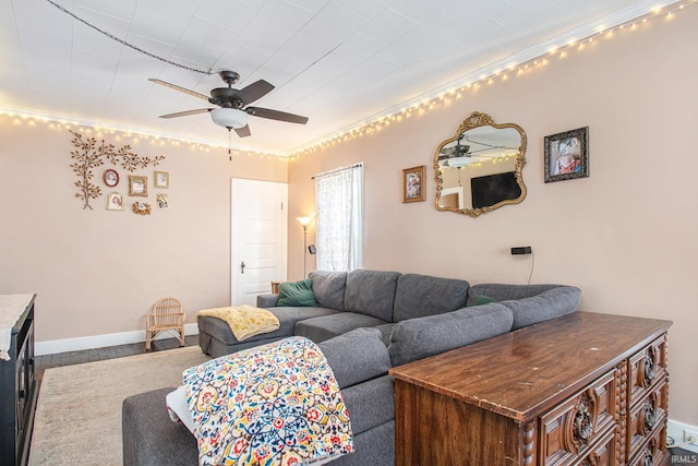 living room featuring crown molding, ceiling fan, and wood-type flooring