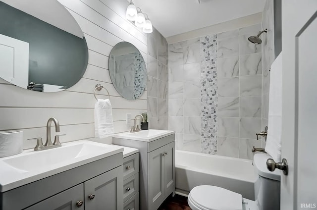 full bathroom with tiled shower / bath combo, vanity, and toilet