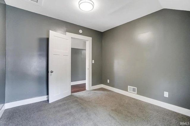 unfurnished room with lofted ceiling and carpet