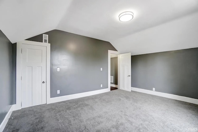 additional living space with vaulted ceiling and carpet