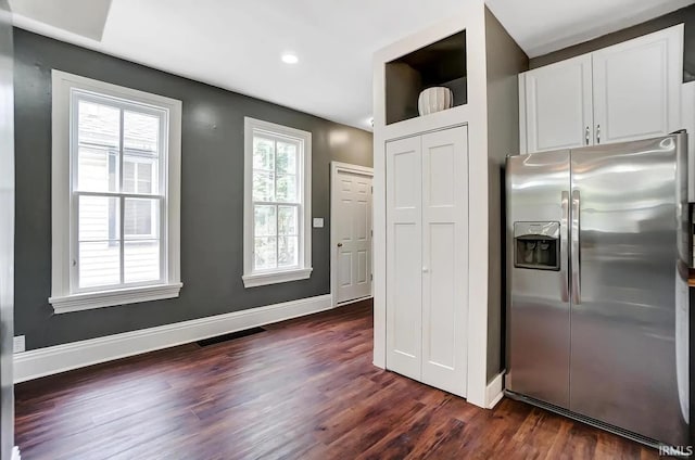 kitchen with white cabinetry, dark wood-type flooring, and stainless steel fridge with ice dispenser