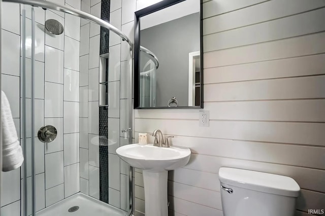 bathroom with tiled shower and toilet