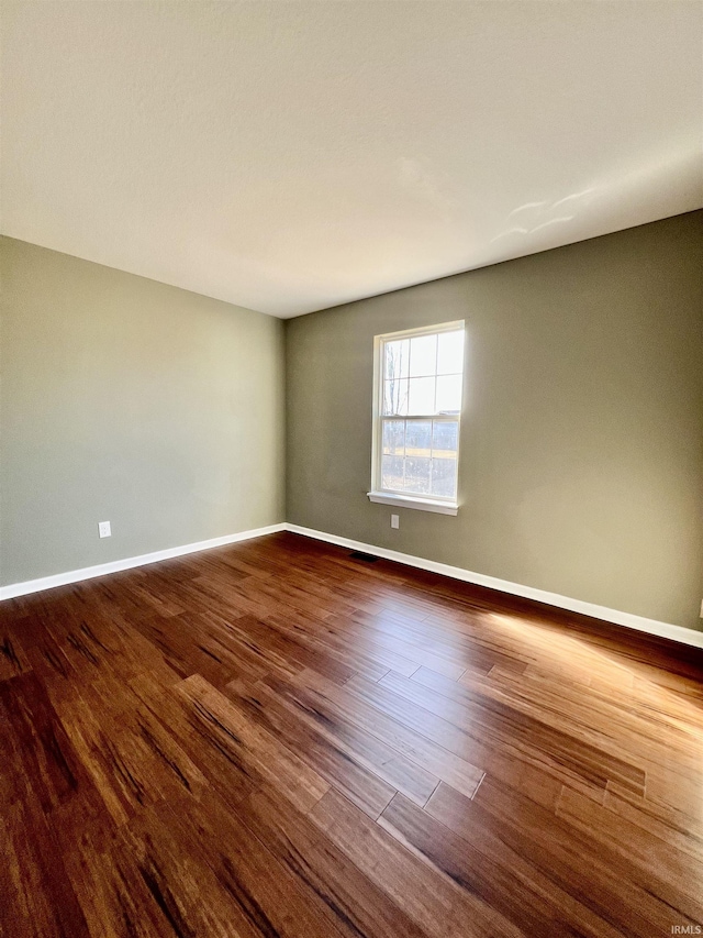 spare room featuring dark hardwood / wood-style flooring