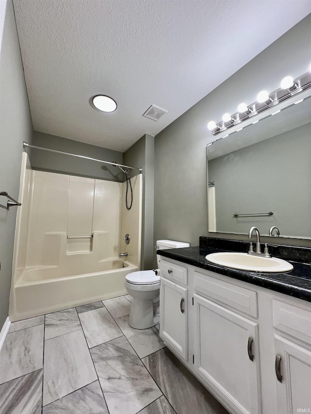 full bathroom featuring toilet, vanity, a textured ceiling, and shower / bathing tub combination