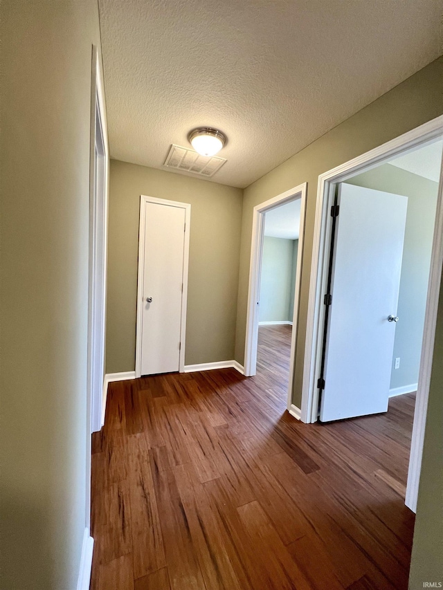 interior space featuring hardwood / wood-style floors and a textured ceiling