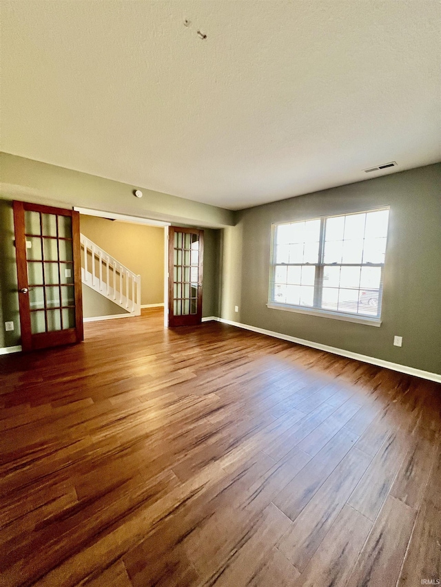 unfurnished living room with hardwood / wood-style flooring