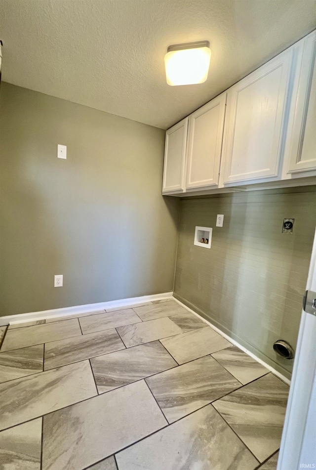 washroom featuring cabinets, electric dryer hookup, washer hookup, and a textured ceiling