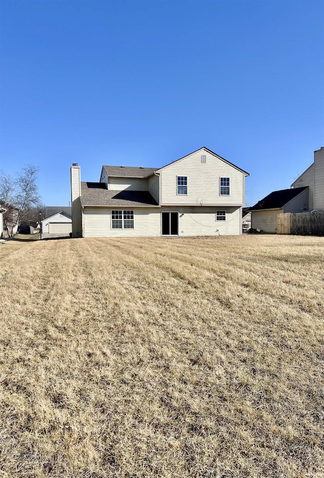 back of house featuring a yard