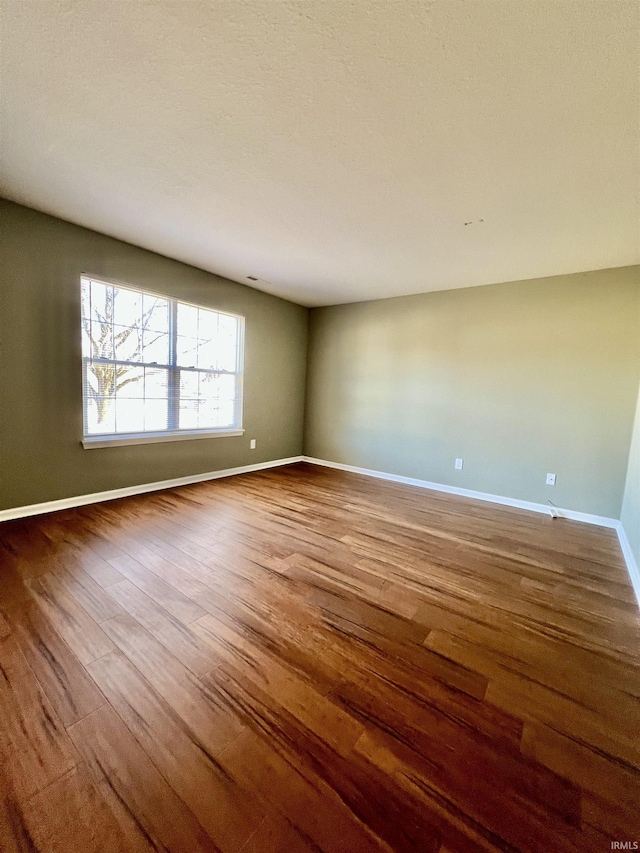 empty room featuring wood-type flooring