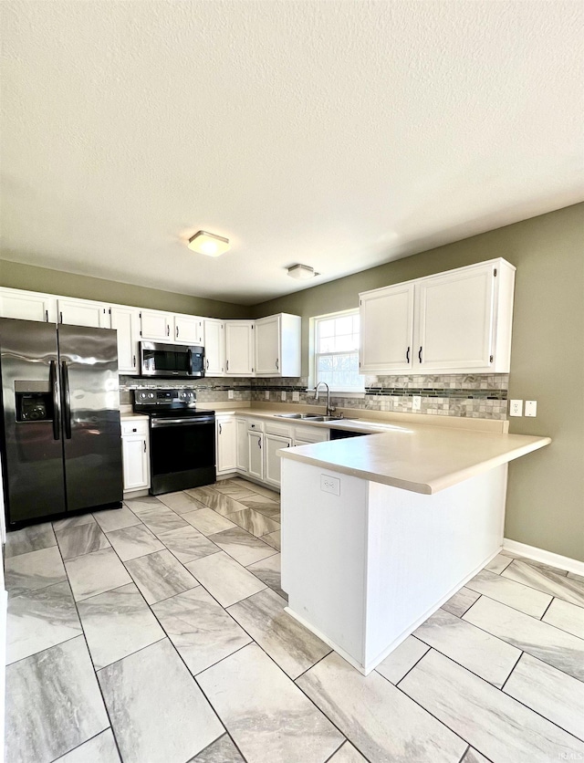 kitchen featuring white cabinetry, appliances with stainless steel finishes, kitchen peninsula, and decorative backsplash