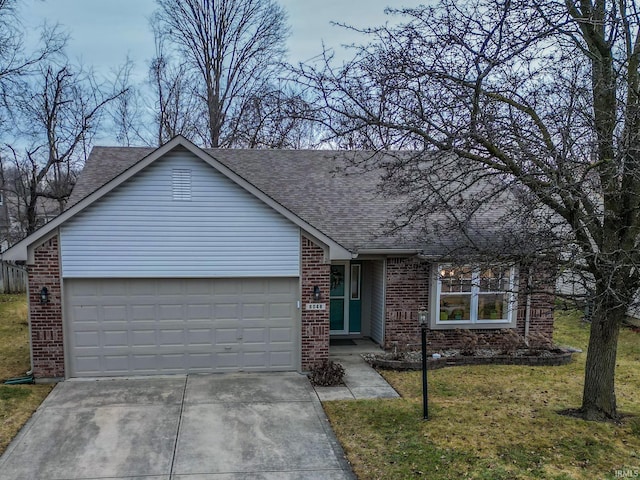 ranch-style home with a garage and a front lawn