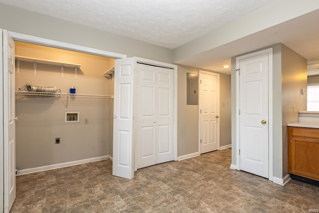 laundry area featuring hookup for a washing machine, electric dryer hookup, and a textured ceiling